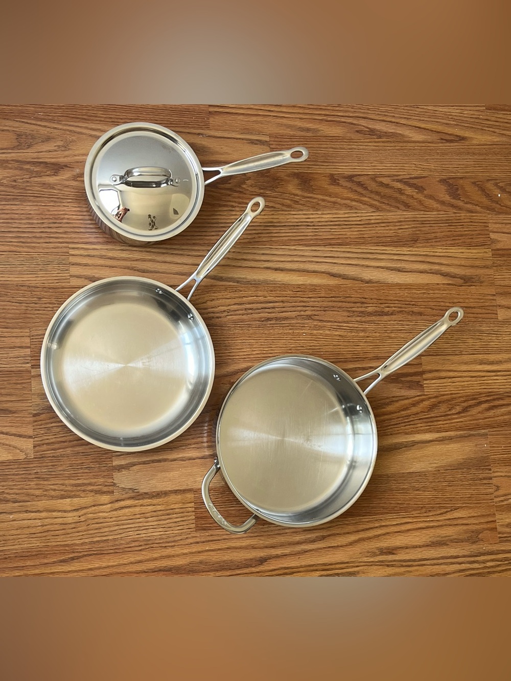 3 piece stainless steel pans and a pot set by Cuisinart